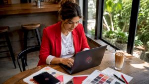 Marketing manager managing brand reputation on laptop